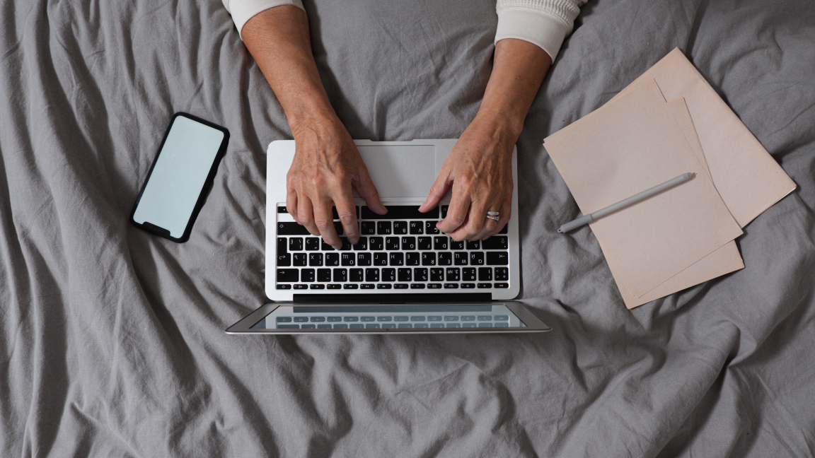 Hands typing on a laptop.