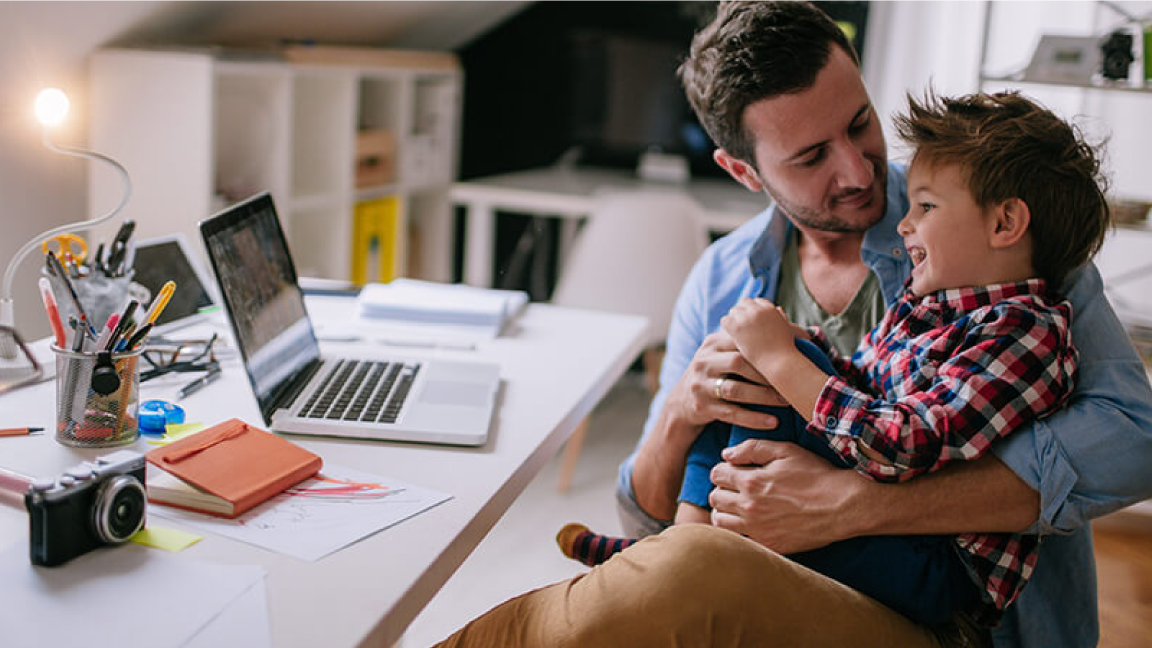 Man working at home with his child.