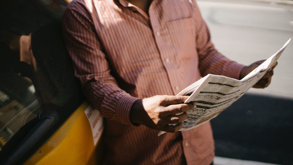 Person reading a newspaper.